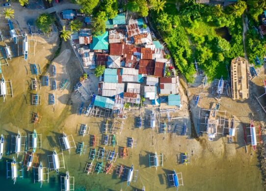 aerial view of houses near body of water during daytime